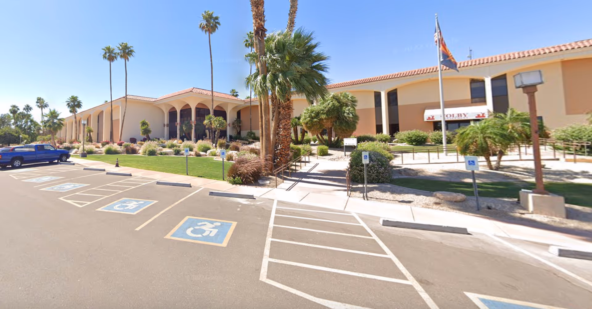 Exterior view of Golden Heart Senior Care building with palm trees and handicap parking.