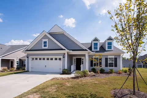 Exterior front view of Renaissance Care Home at Neuse River Estates with a garage