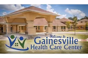 Front exterior view of Gainesville Health Care Center with a covered entrance and sign.