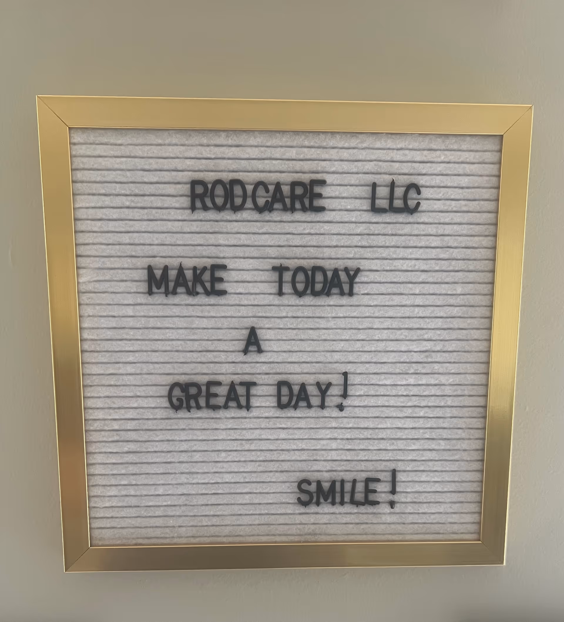 Framed interior sign reads RodCare LLC: Make today a great day, smile.