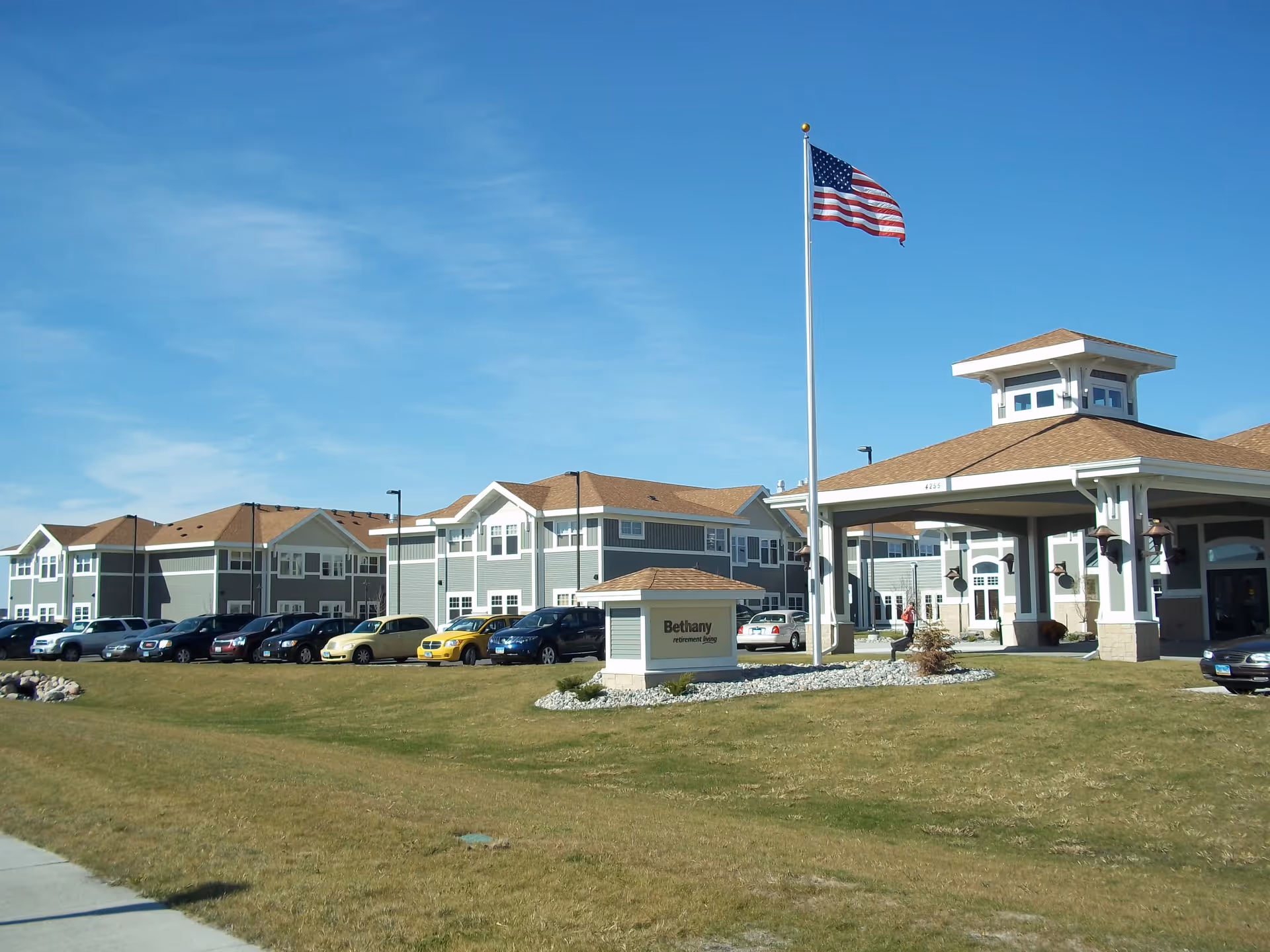 Bethany on 42nd senior living campus with flagpole, parking, and well-kept lawn.