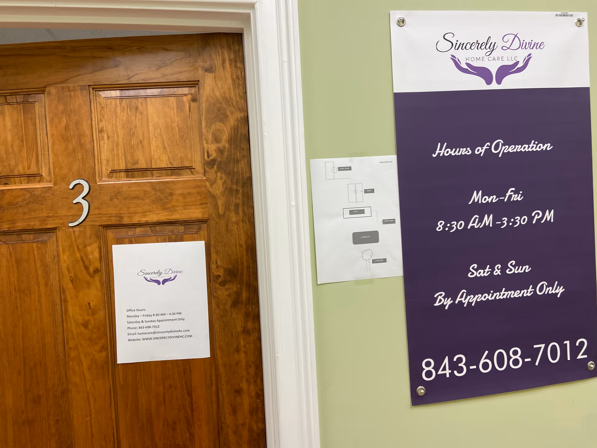 Interior hallway with wooden door labeled 3 and large purple sign on a green wall.