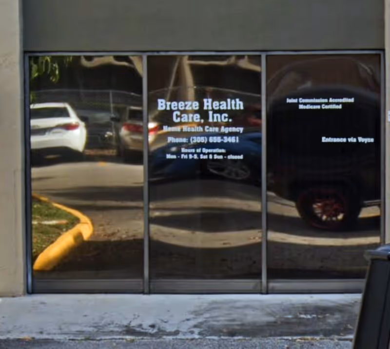 Glass entrance doors show Breeze Health Care, Inc. branding with cars reflected outside.