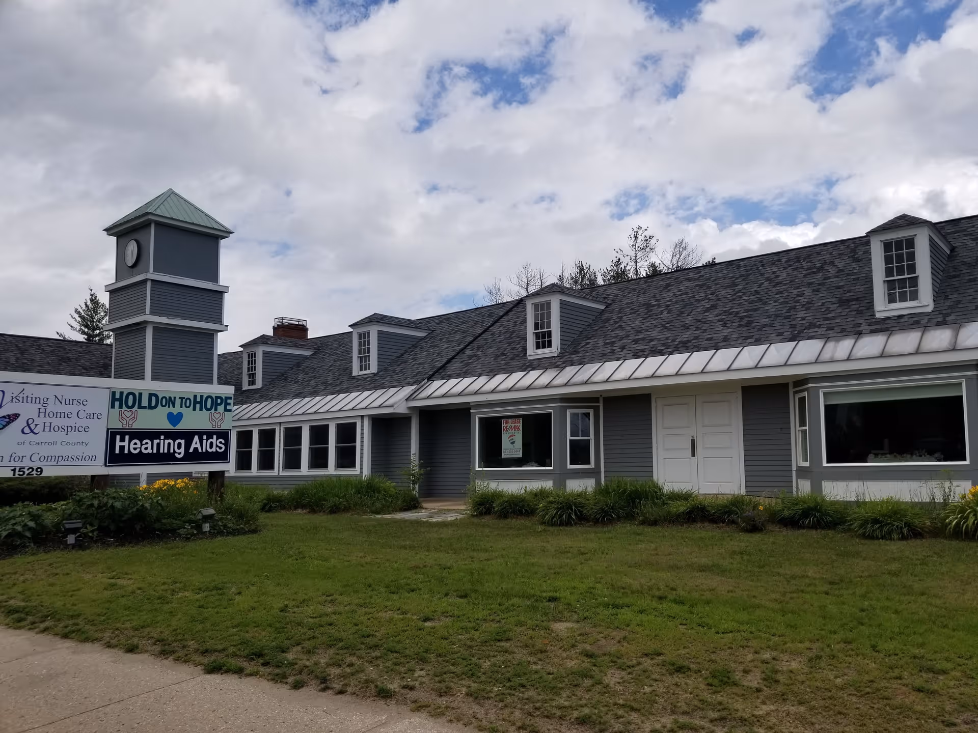 Exterior view of Visiting Nurse Home Care and Hospice building with signage.