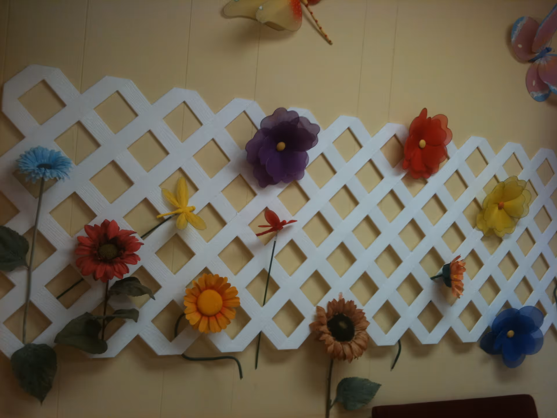 Interior wall features a white lattice panel adorned with colorful paper flowers.