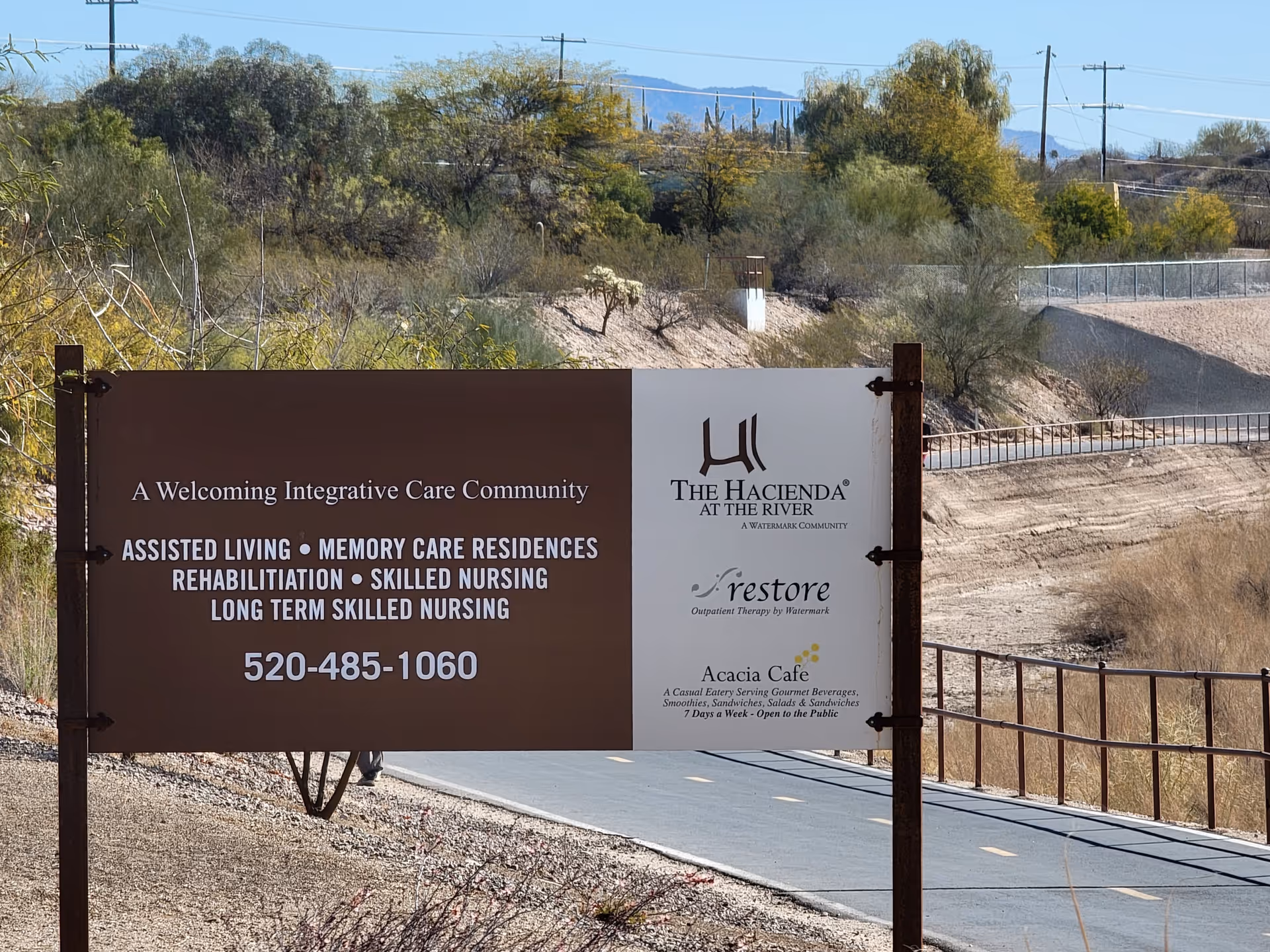Entrance sign for Casa De La Luz Hospice at The Hacienda along a desert road
