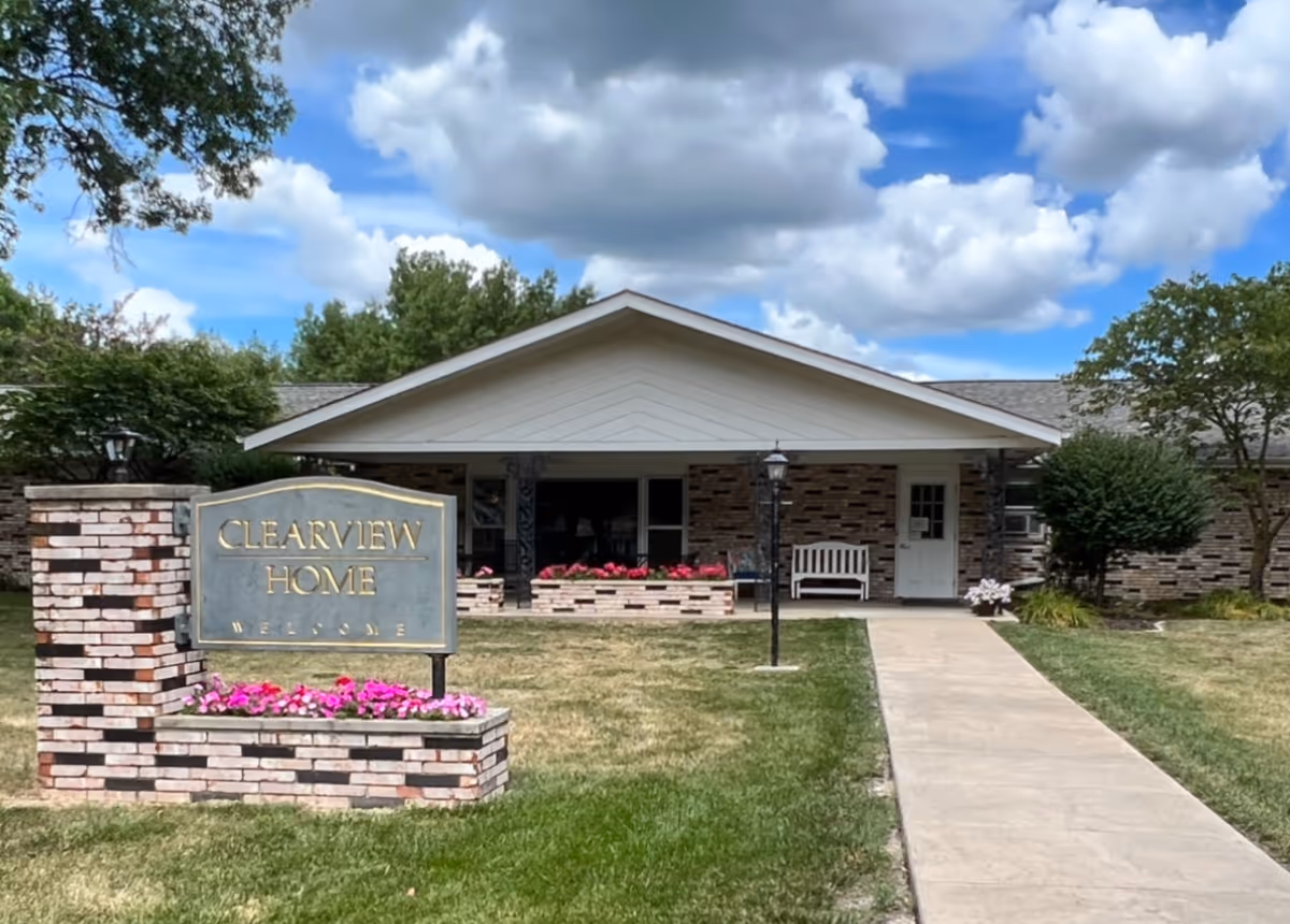 Front view of Clearview Home Mount Ayr with sign, path, and entrance.