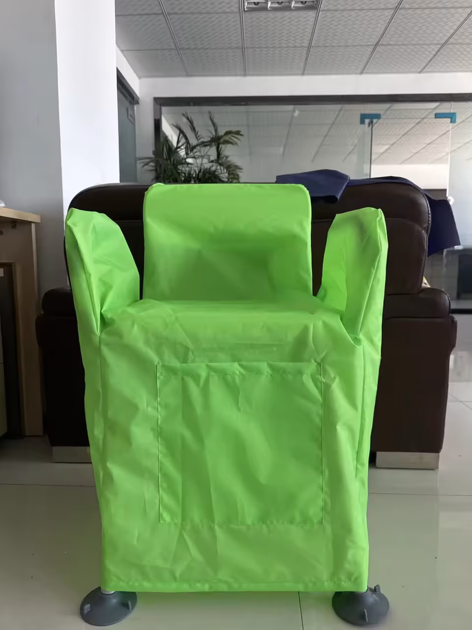 Bright neon green chair cover on a lounge chair in a facility lobby.