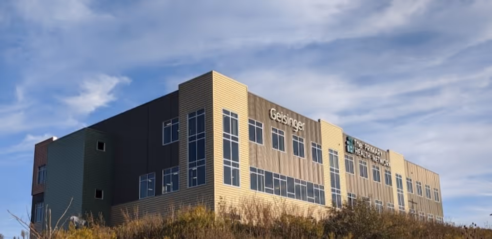 Geisinger Hospice building with blue sky and numerous windows