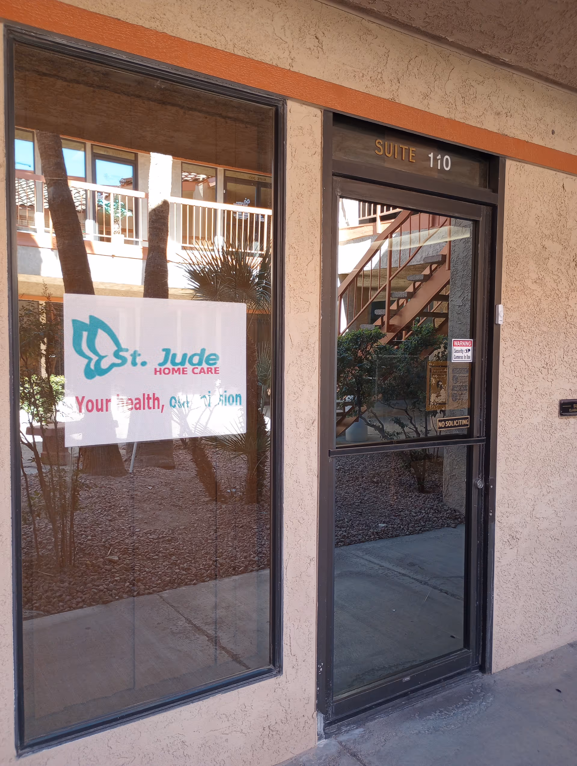 Entrance of St. Jude Home Care with glass doors and suite 110.