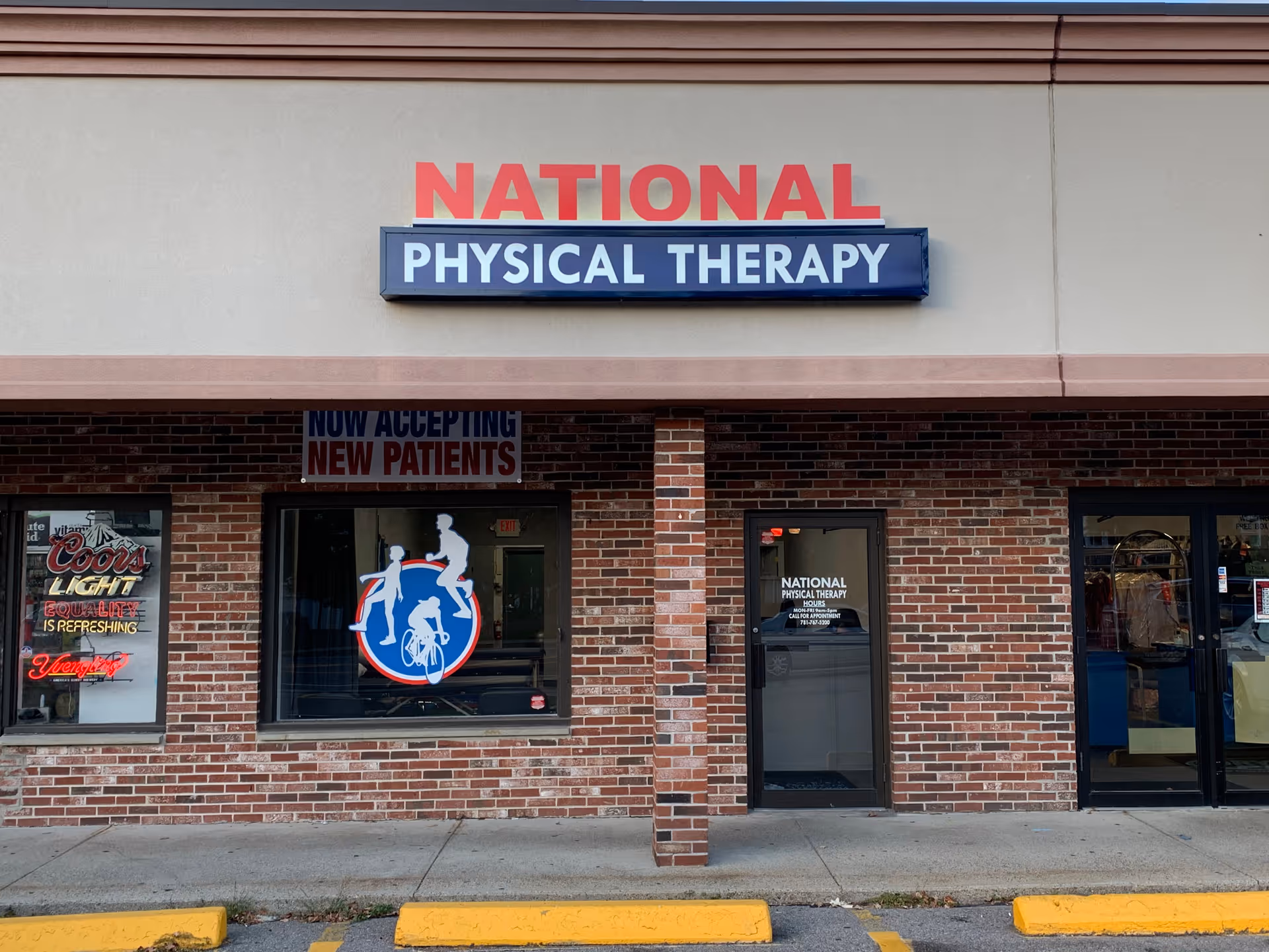 Brick storefront with 'NATIONAL PHYSICAL THERAPY' sign above the entrance