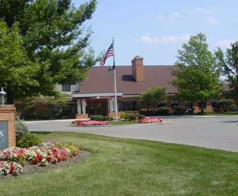 Front exterior view of Kingston Residence of Marion with landscaping and flagpole.