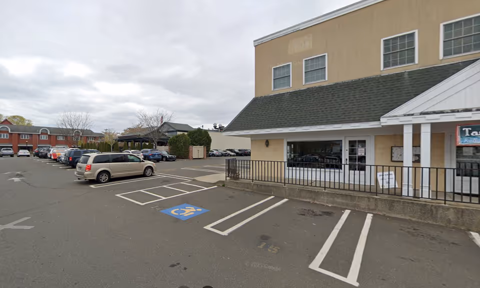 Front exterior of a senior services facility with parking and a visible handicapped space.