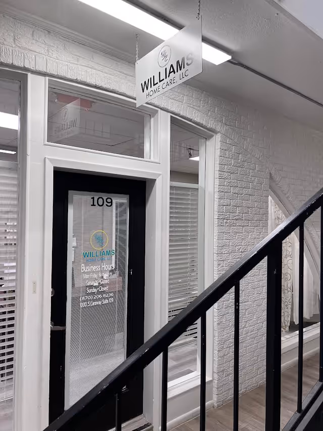 Interior hallway featuring door labeled 109 and hanging Williams Home Care sign.