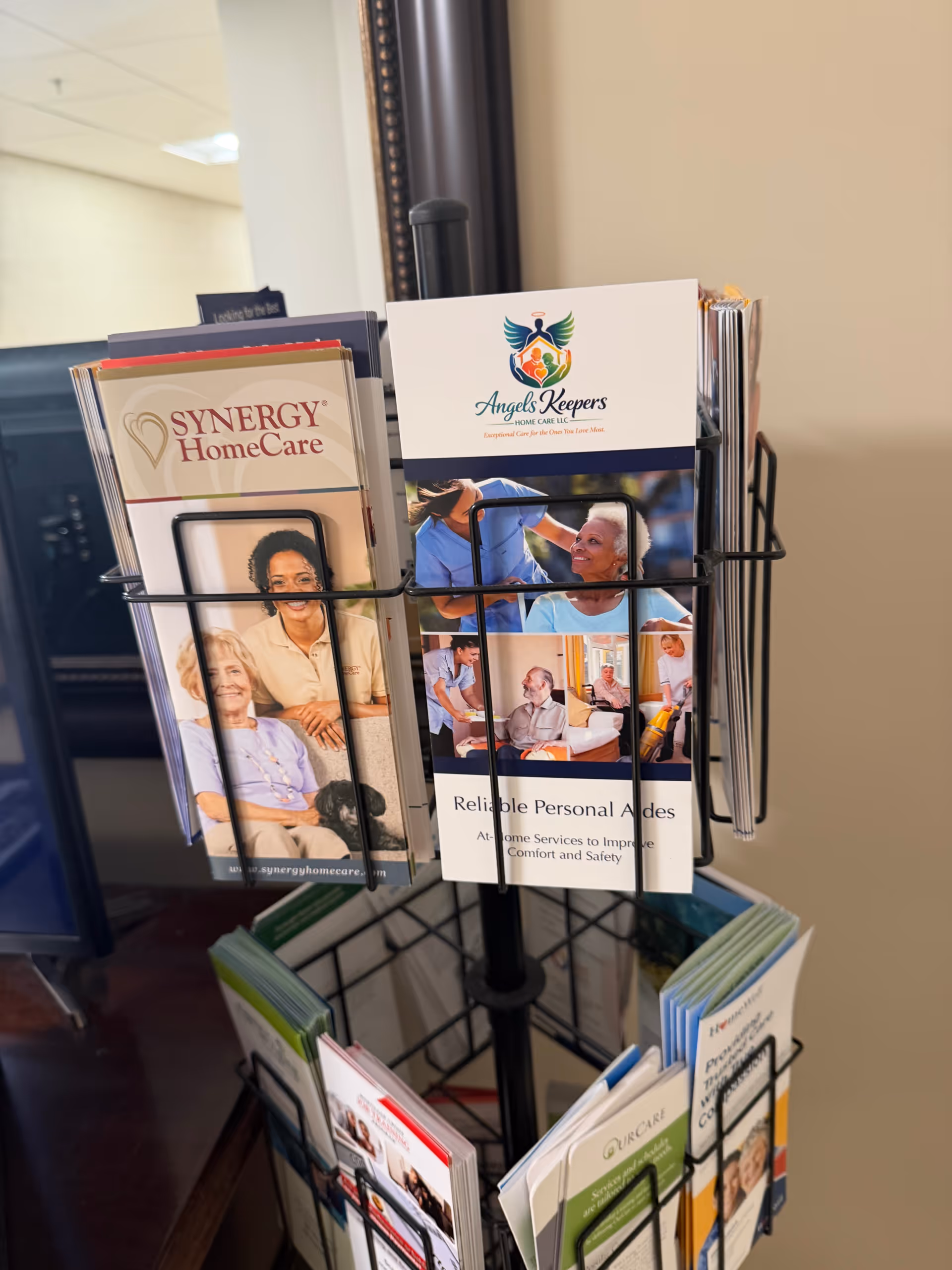 Indoor brochure rack displaying Angels Keepers Home Care LLC pamphlets.