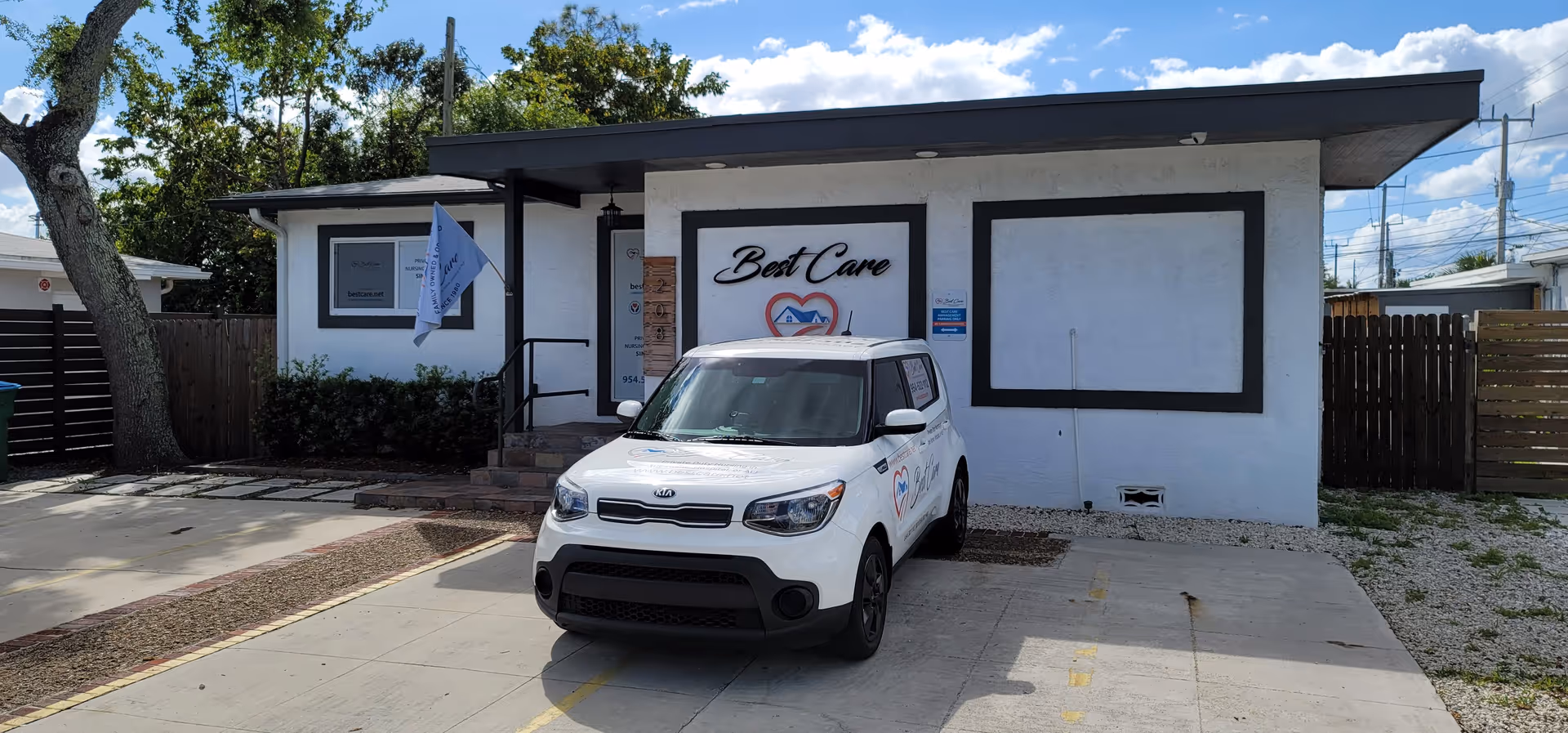 White single-story facility with Best Care sign and a white SUV parked out front.