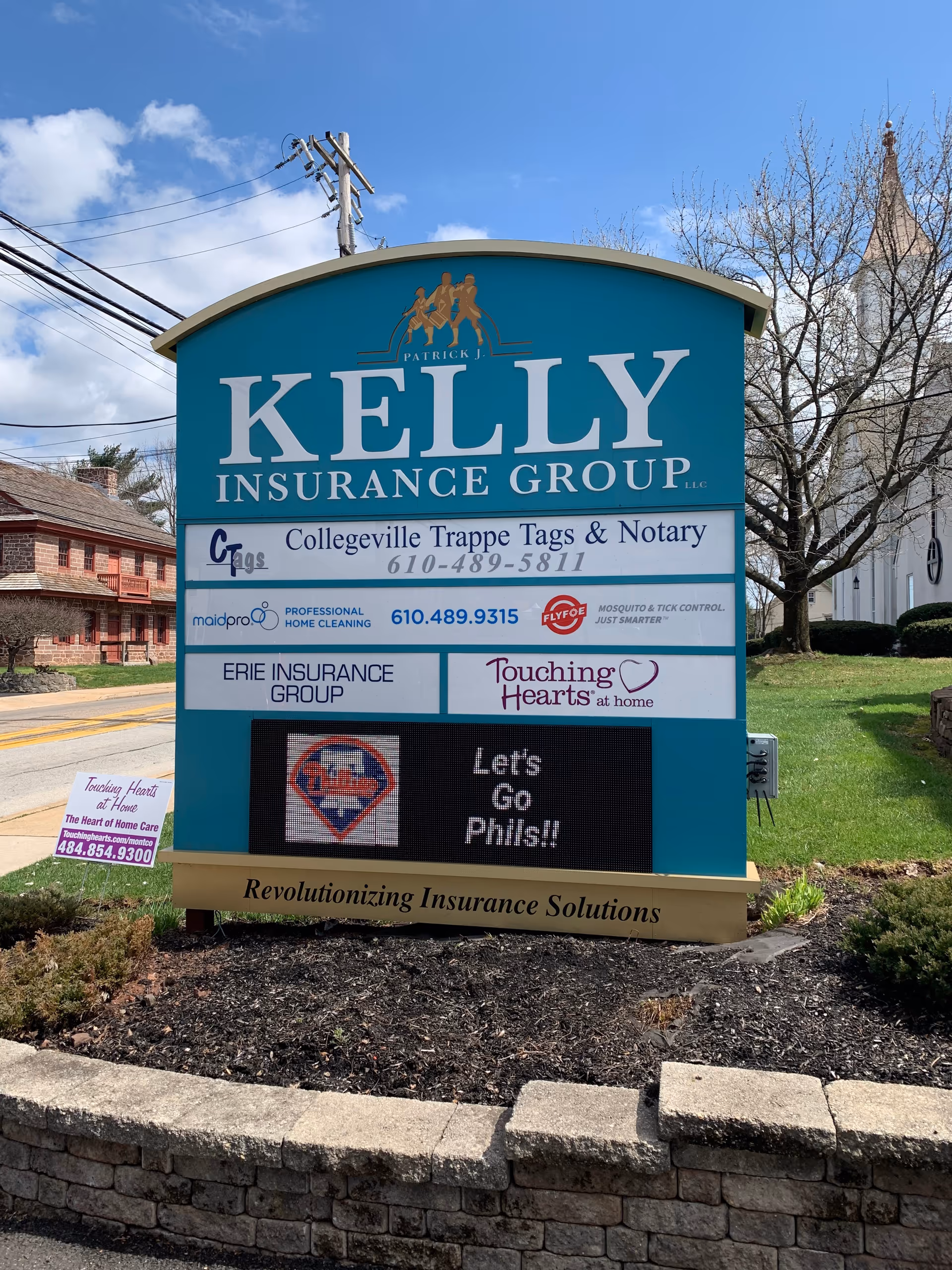 Exterior signboard advertising Touching Hearts at Home alongside other businesses in Montco PA