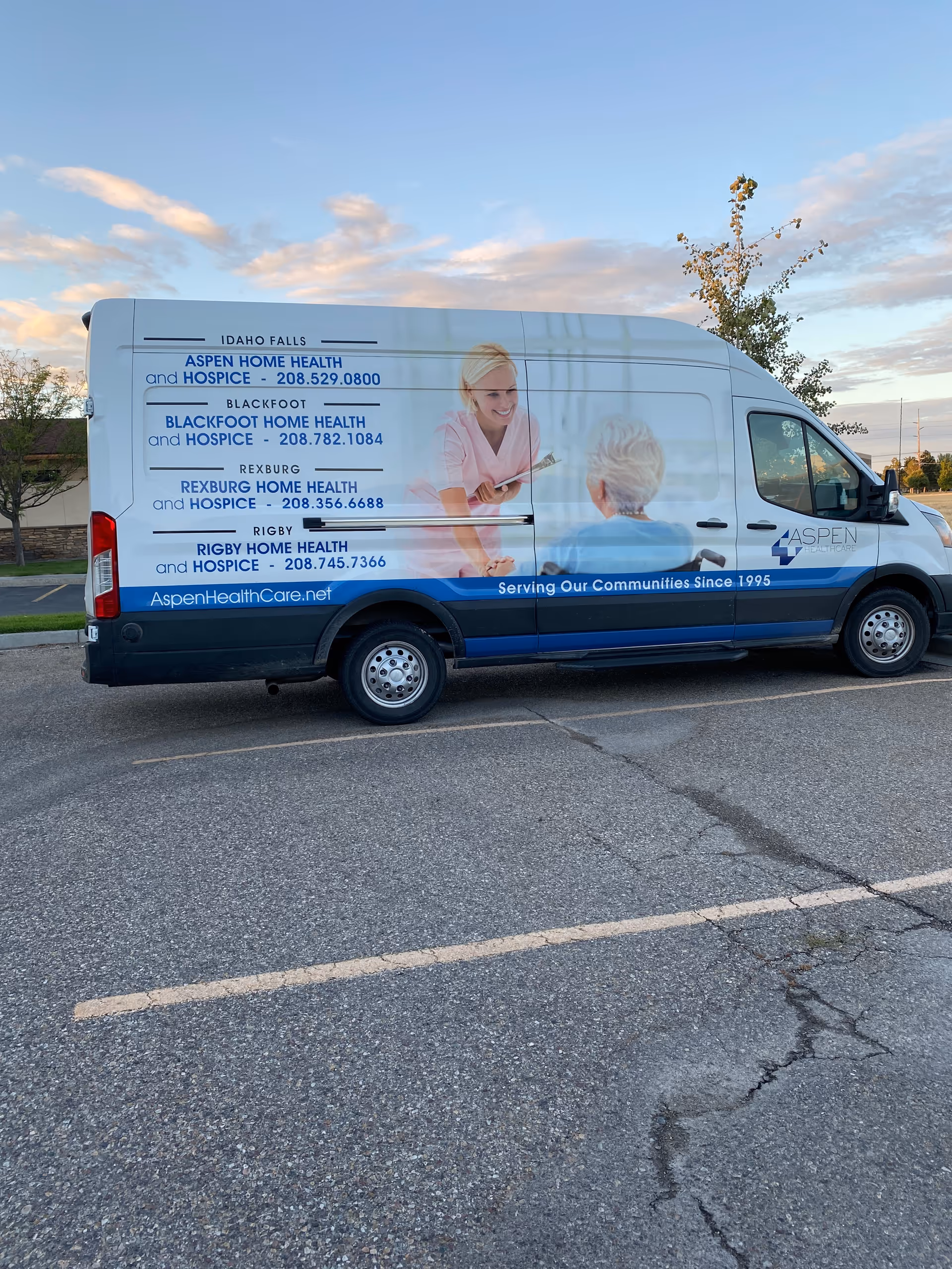 White Aspen Home Health and Hospice van parked in a lot displaying text and an image.