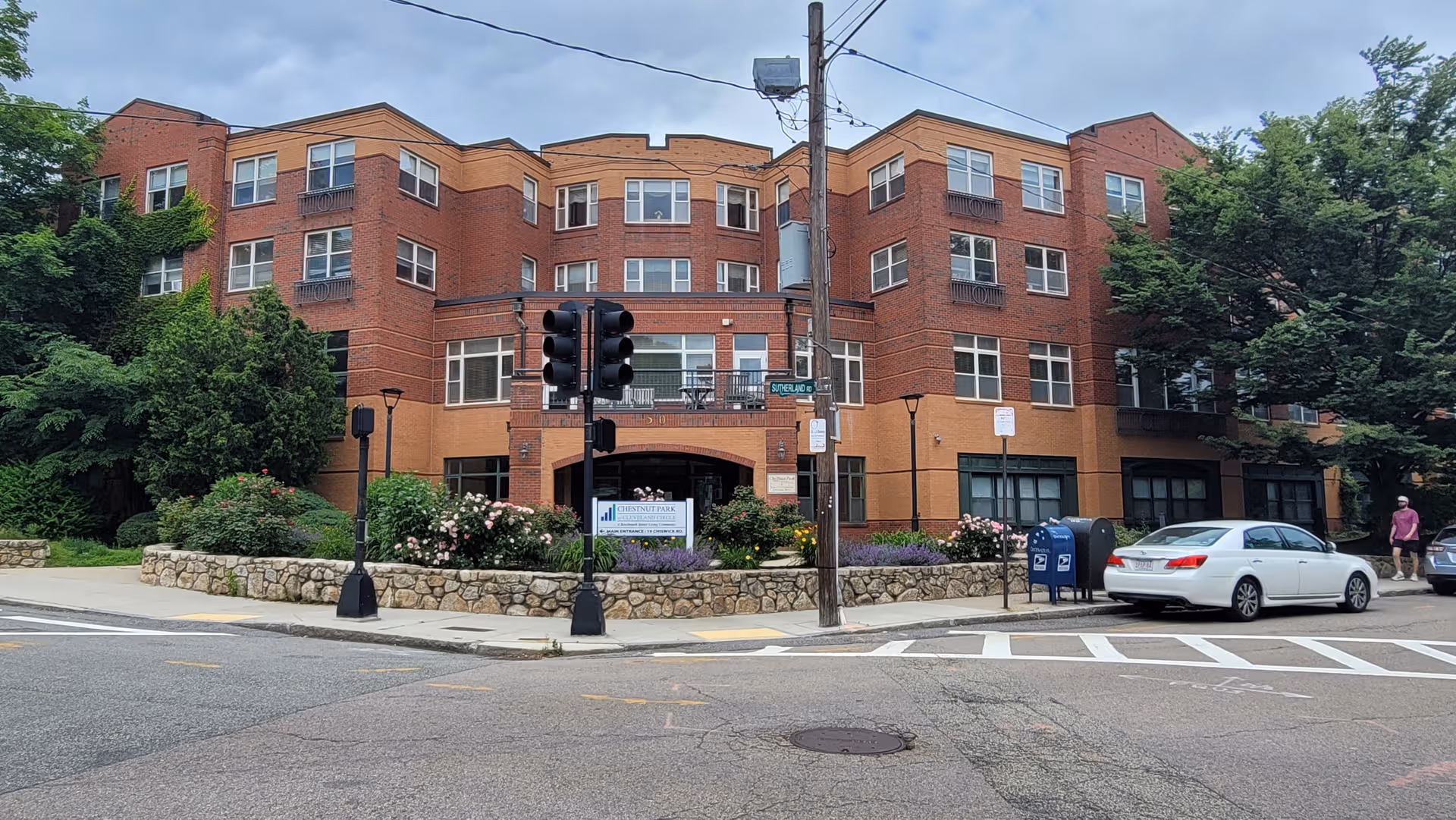 Chestnut Park at Cleveland Circle: brick, multi-story senior living building facing the street.