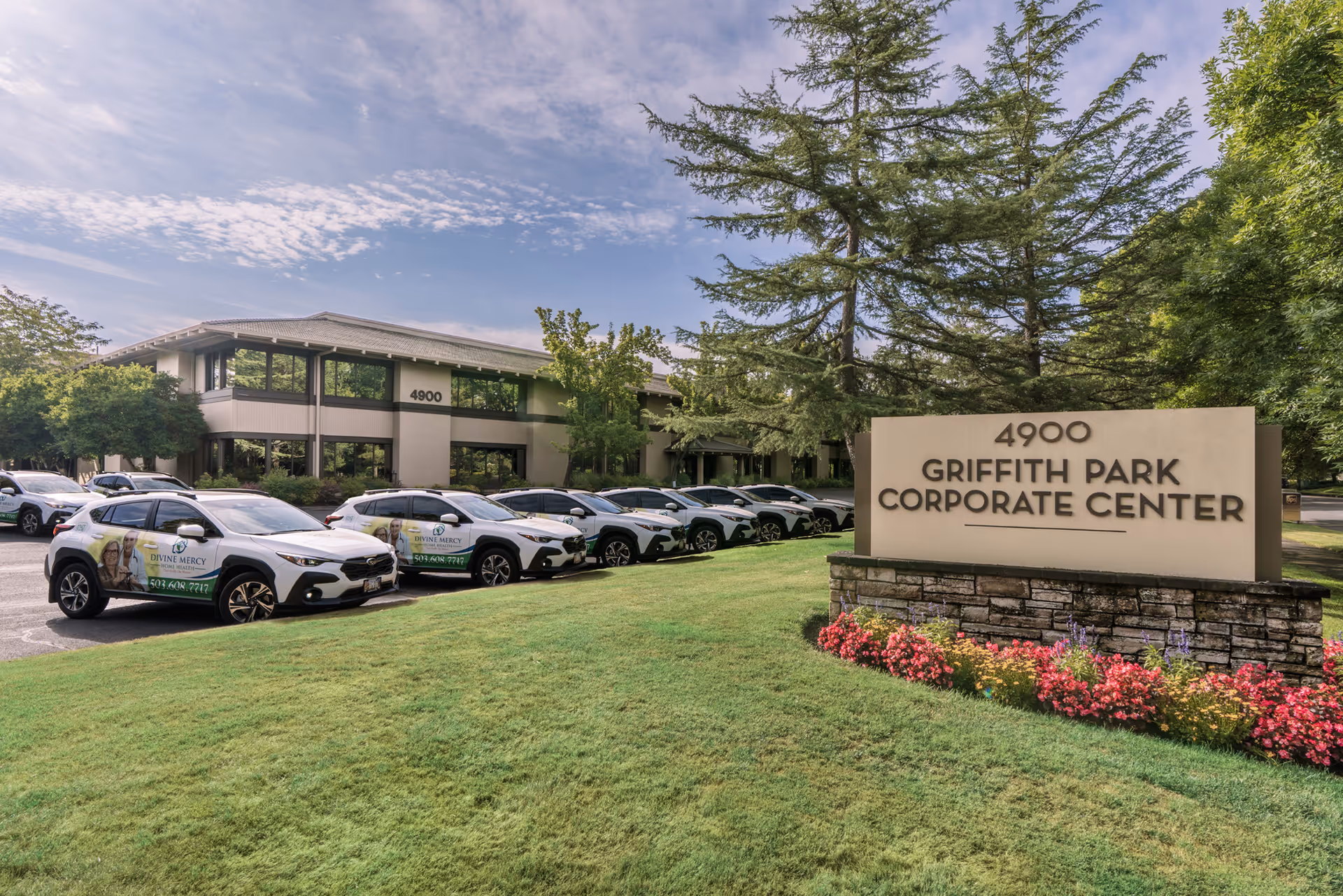 Front exterior of Griffin Park Corporate Center with Divine Mercy Home Health cars.