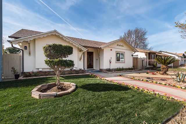 Front view of Northridge Valley Senior Living exterior with lawn and walkway.