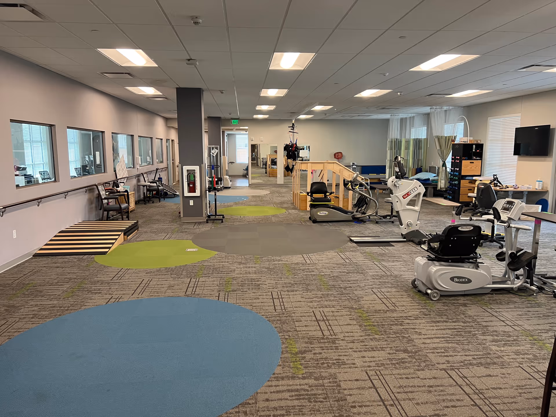 Senior living fitness center with cardio machines and open exercise area
