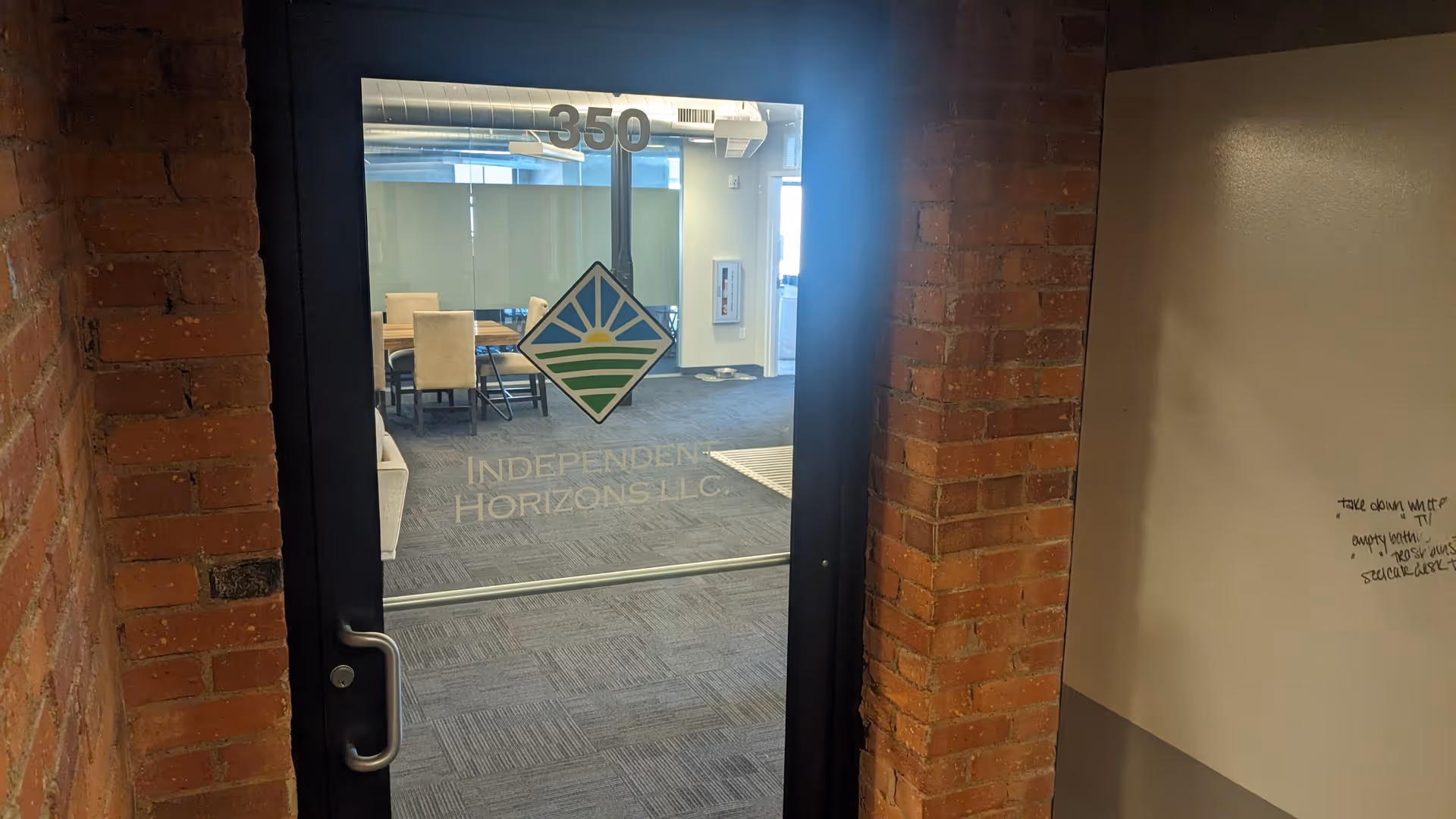 Glass door labeled Independent Horizons LLC opens into a conference room visible through the doorway.