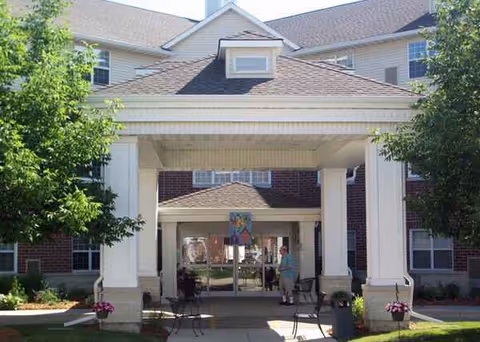 Heritage Woods of Batavia entrance with white columns and a covered walkway.