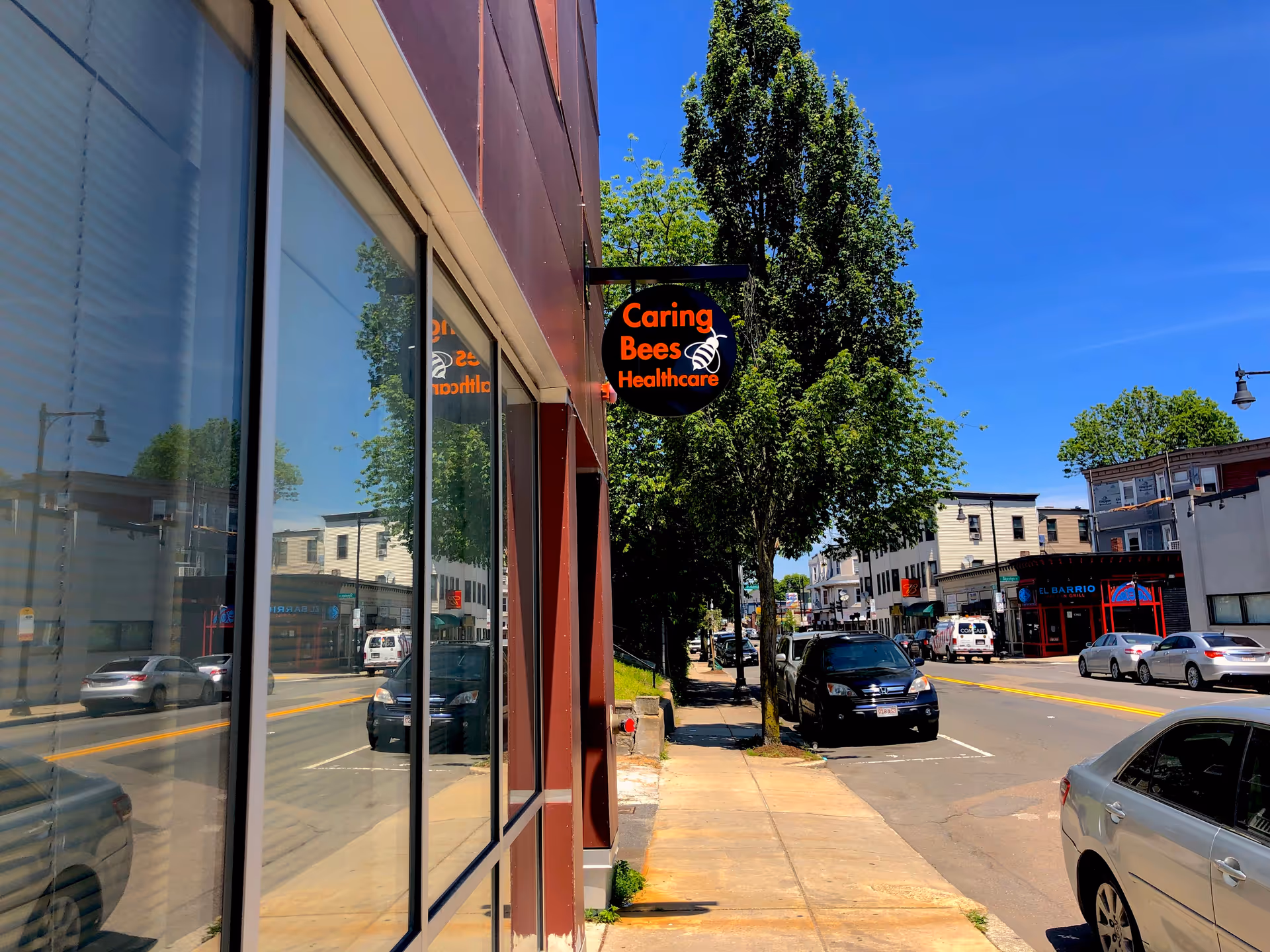 Exterior street view of a building with Caring Bees Healthcare sign.
