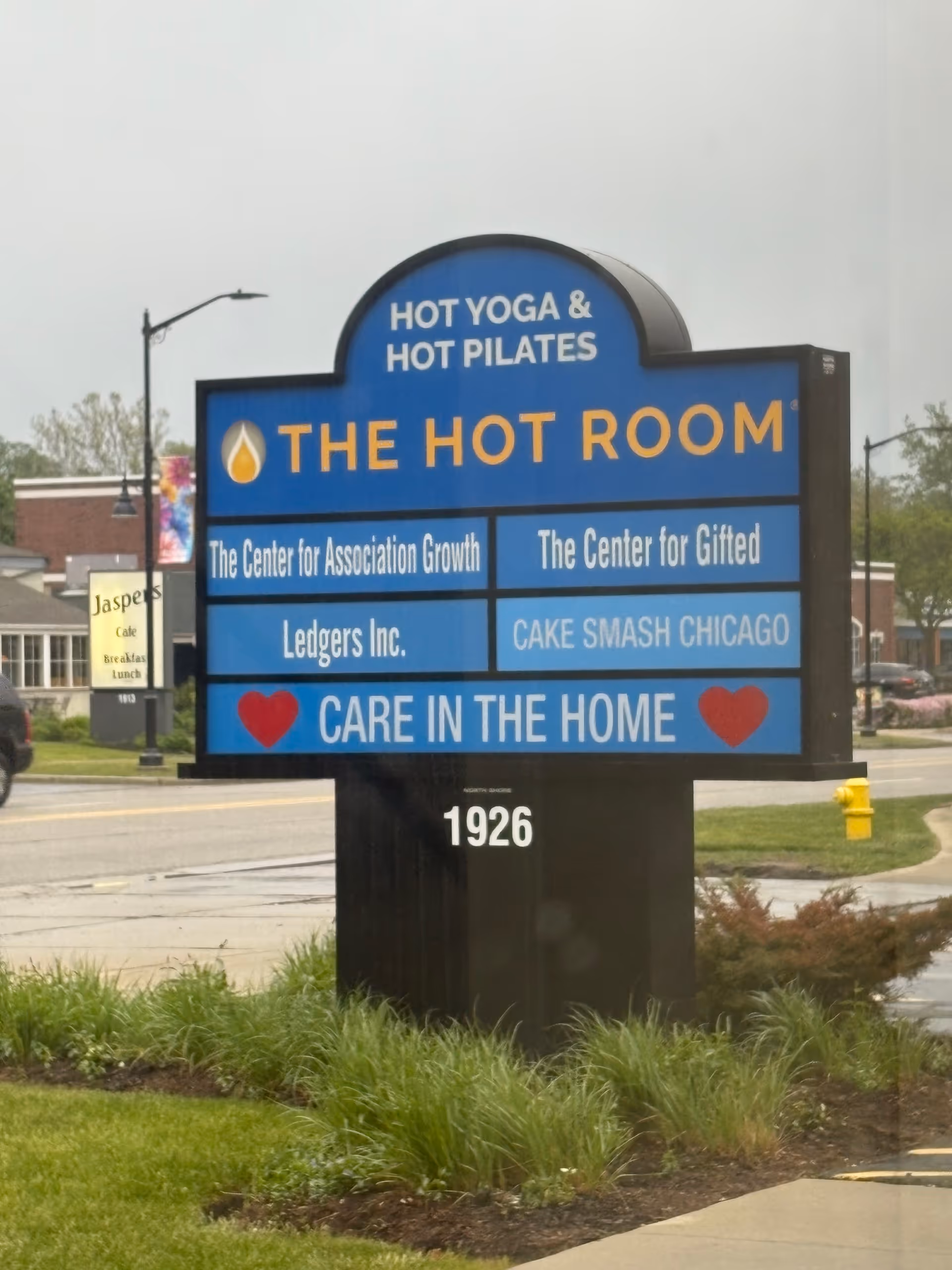 Blue exterior signboard featuring Care In The Home and other business names.