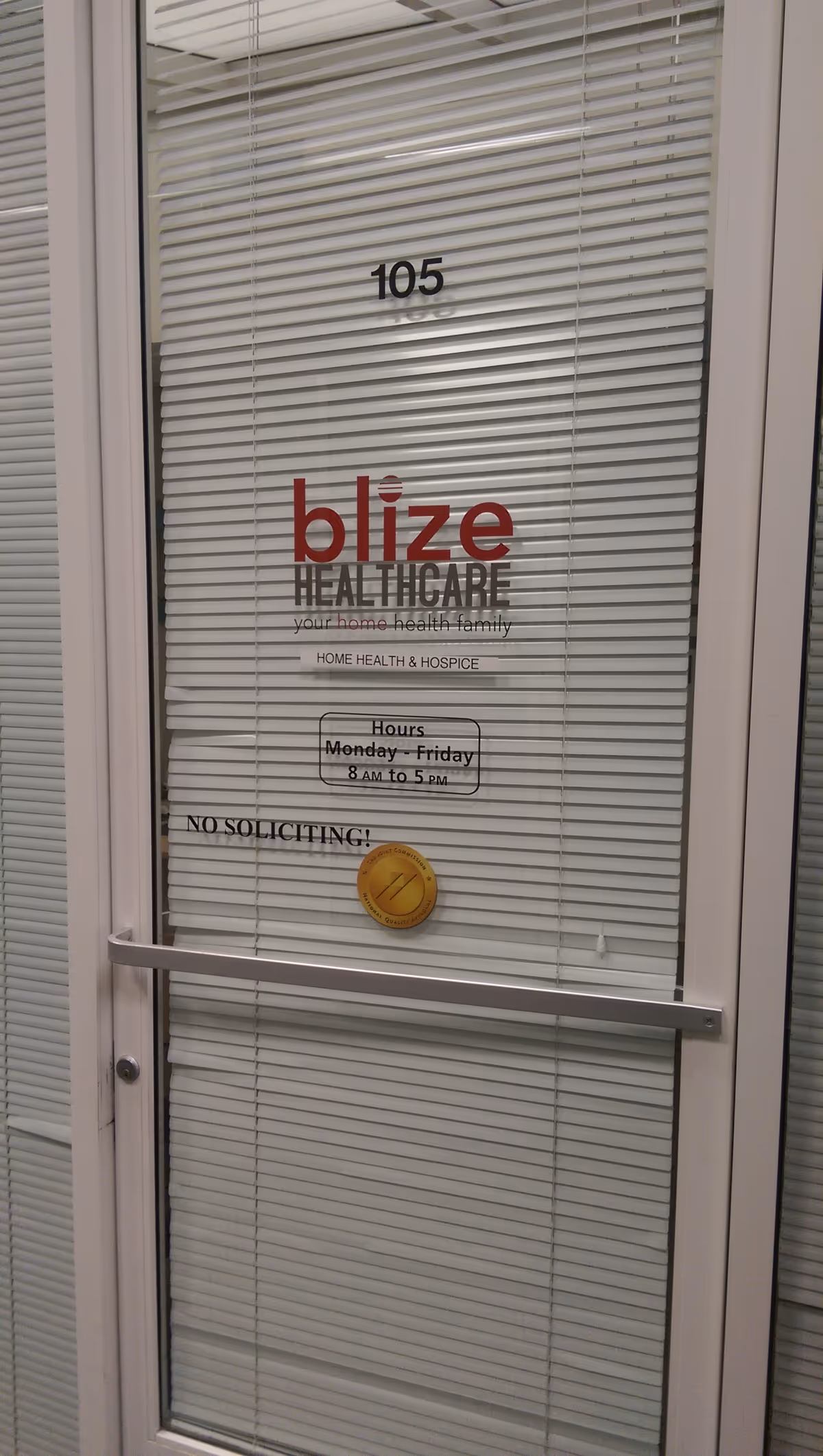 Glass door with blinds displays Blize Healthcare logo and business hours.