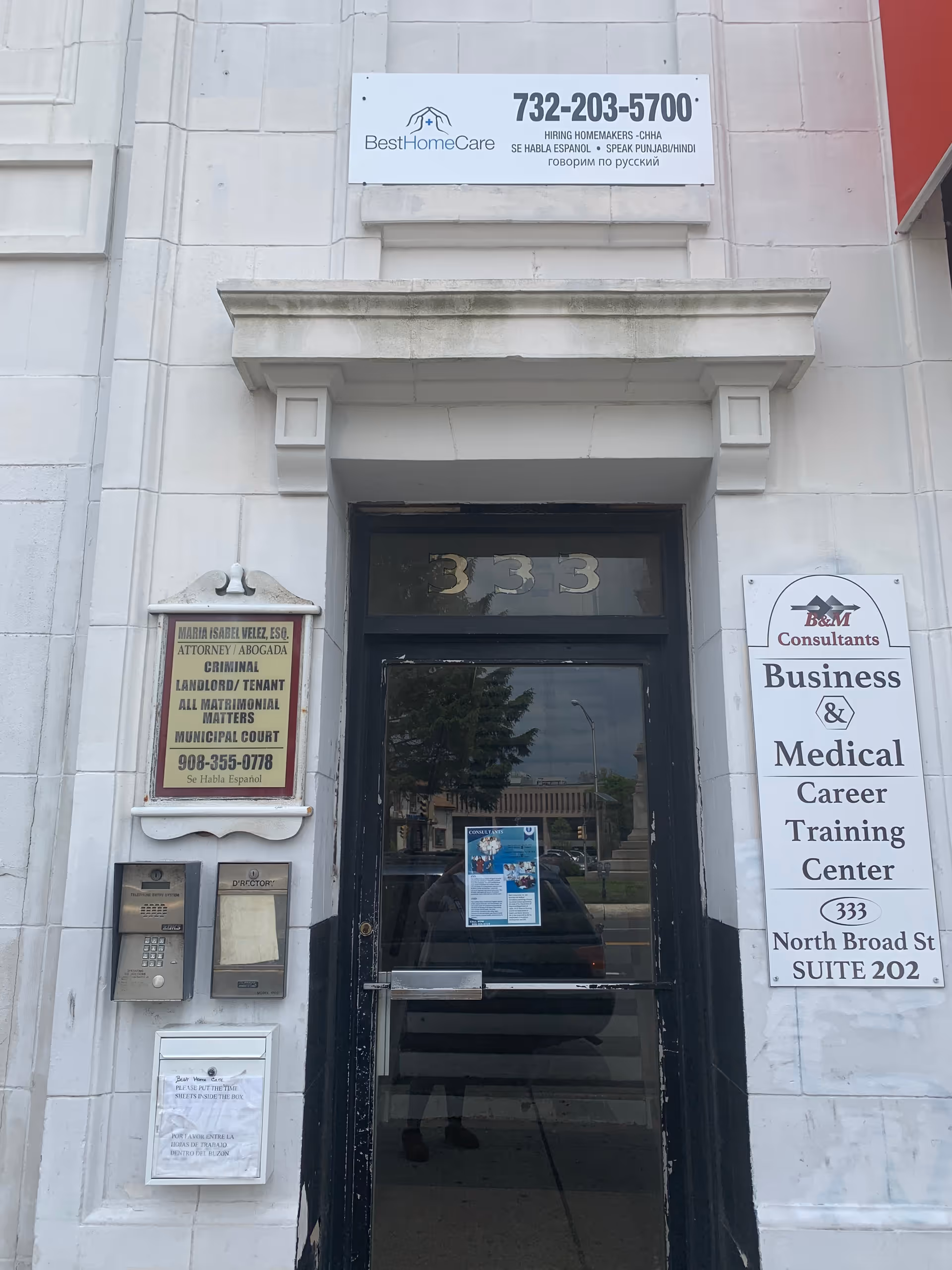 Front entrance of a building with Best Home Care Inc signage and business signs.