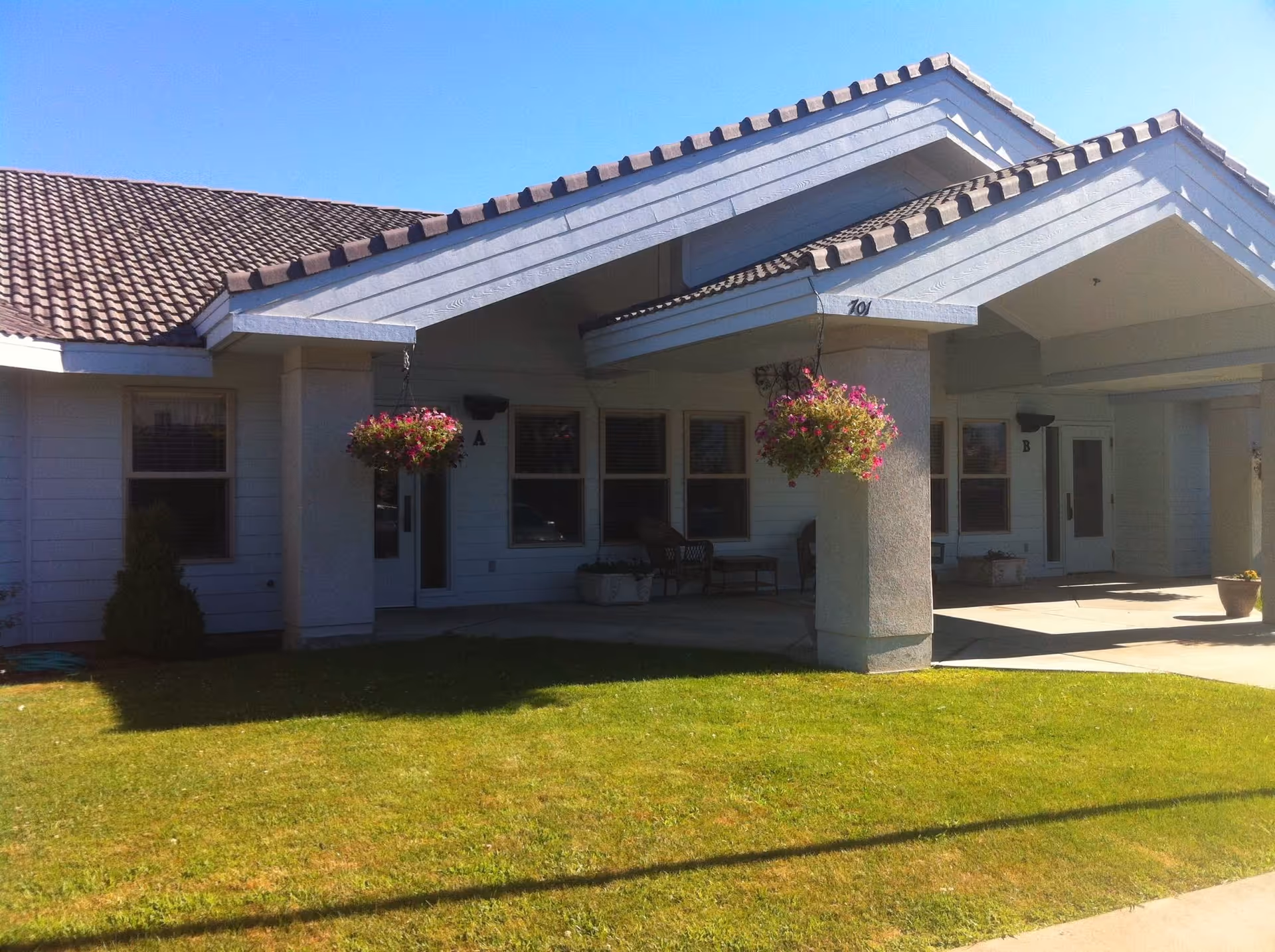 Front exterior of Chandler House senior living facility with a covered porch.
