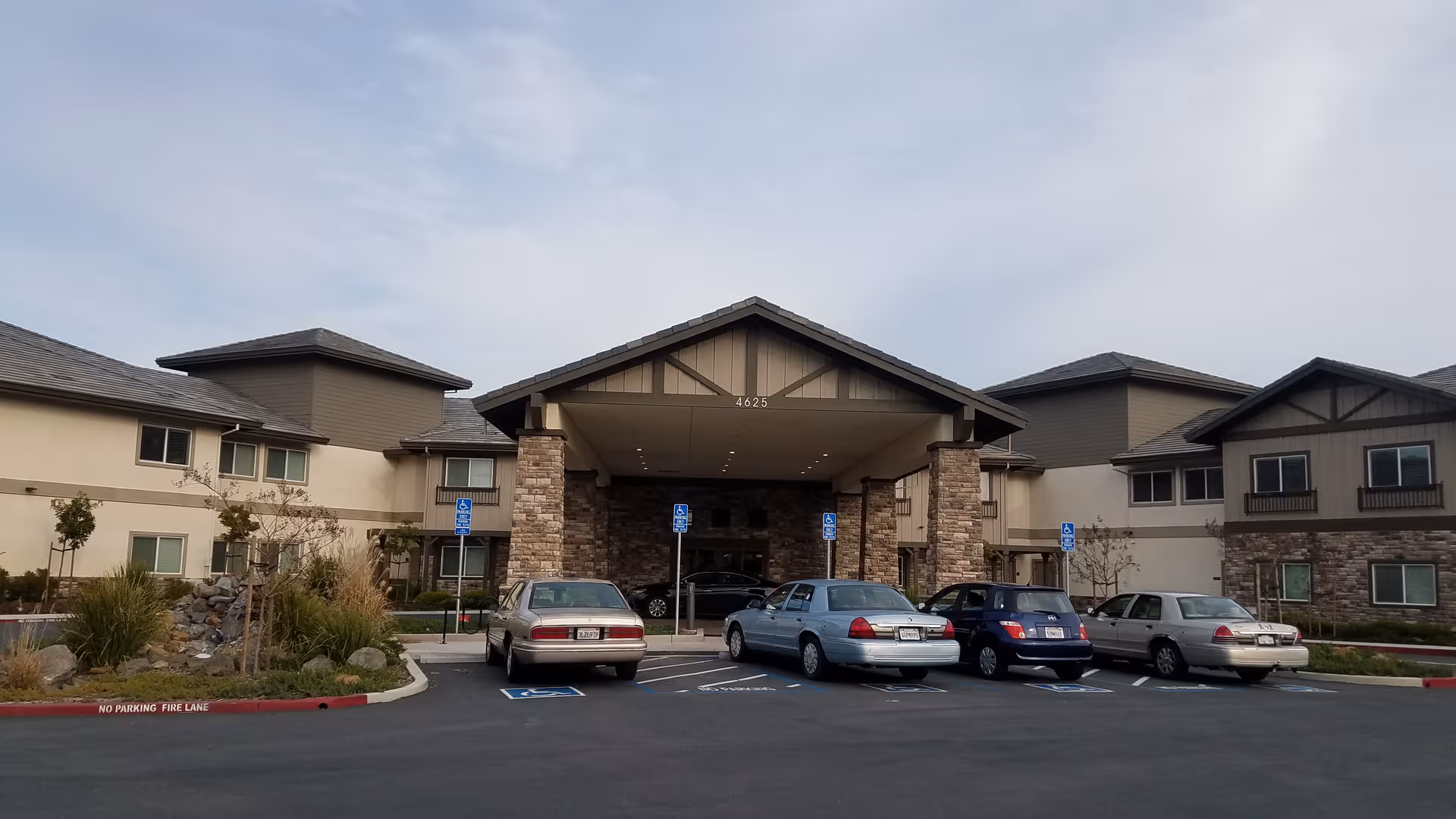 Exterior view of Ivy Park at Rockville entrance with parked cars.
