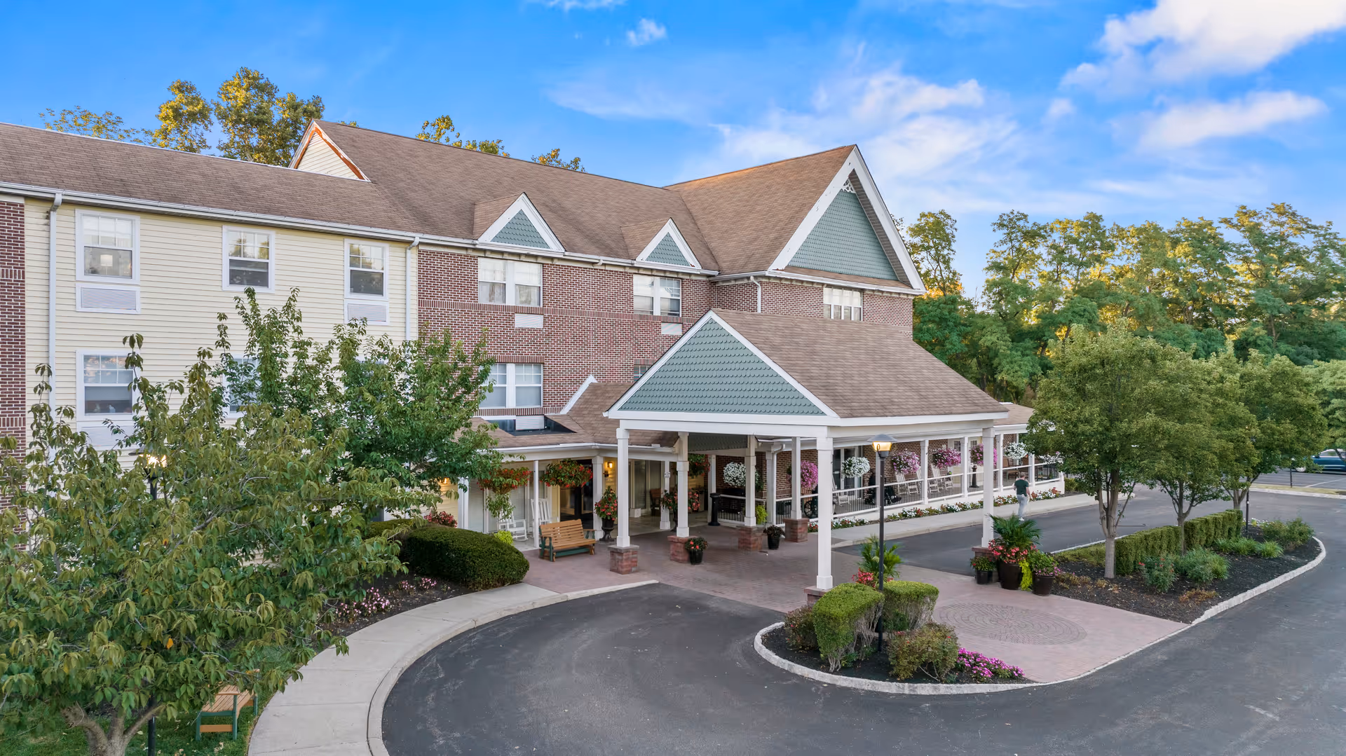 Exterior view of Silver Springs at East Norriton with a covered entrance and circular drive.