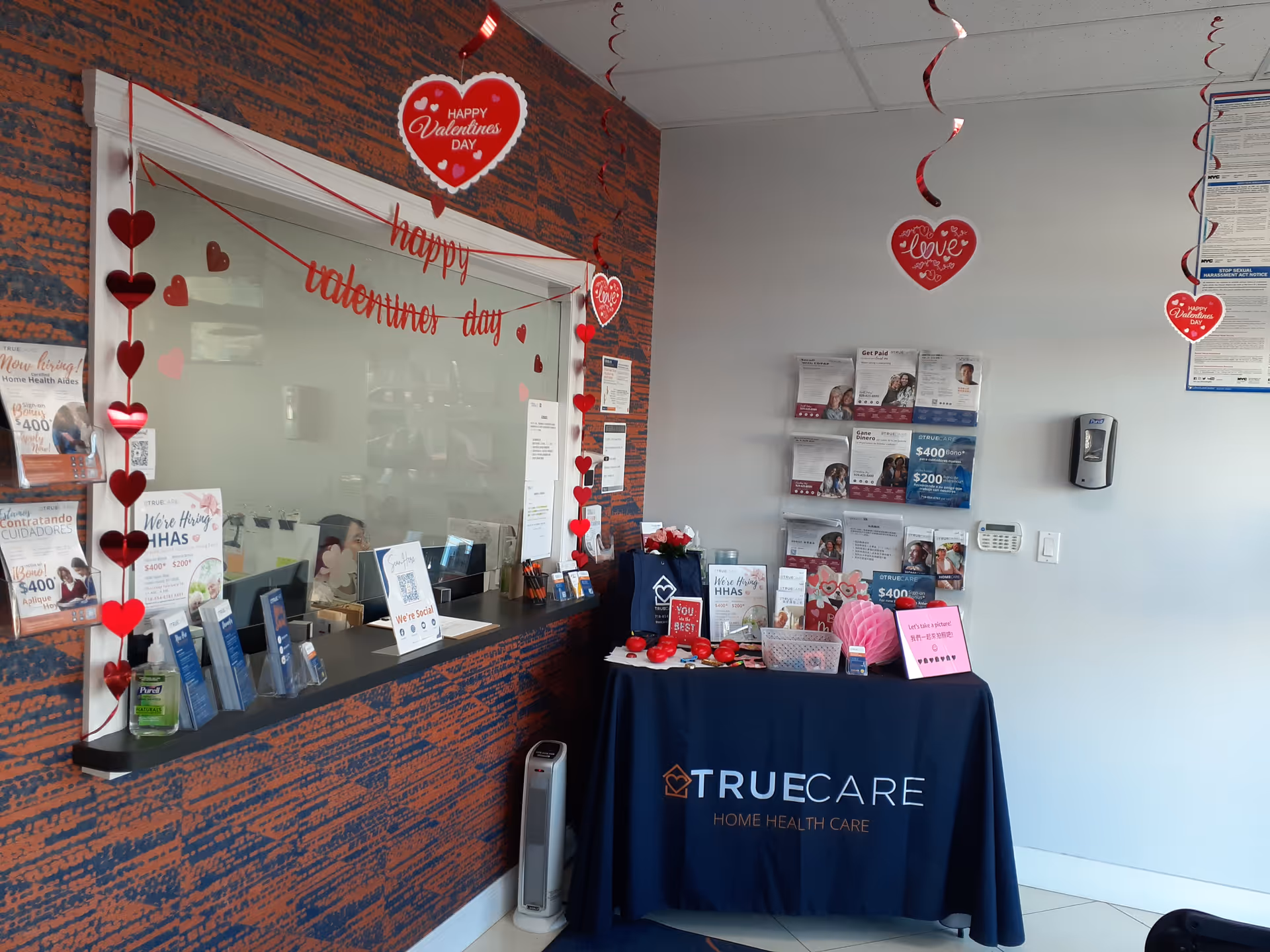 Interior reception area of TrueCare facility with Valentine decor and brochures.