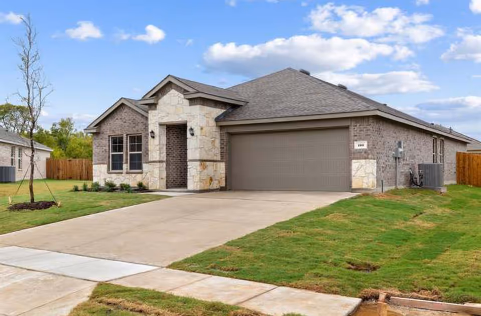 Front exterior of a single-story house with stone accents and a two-car garage.