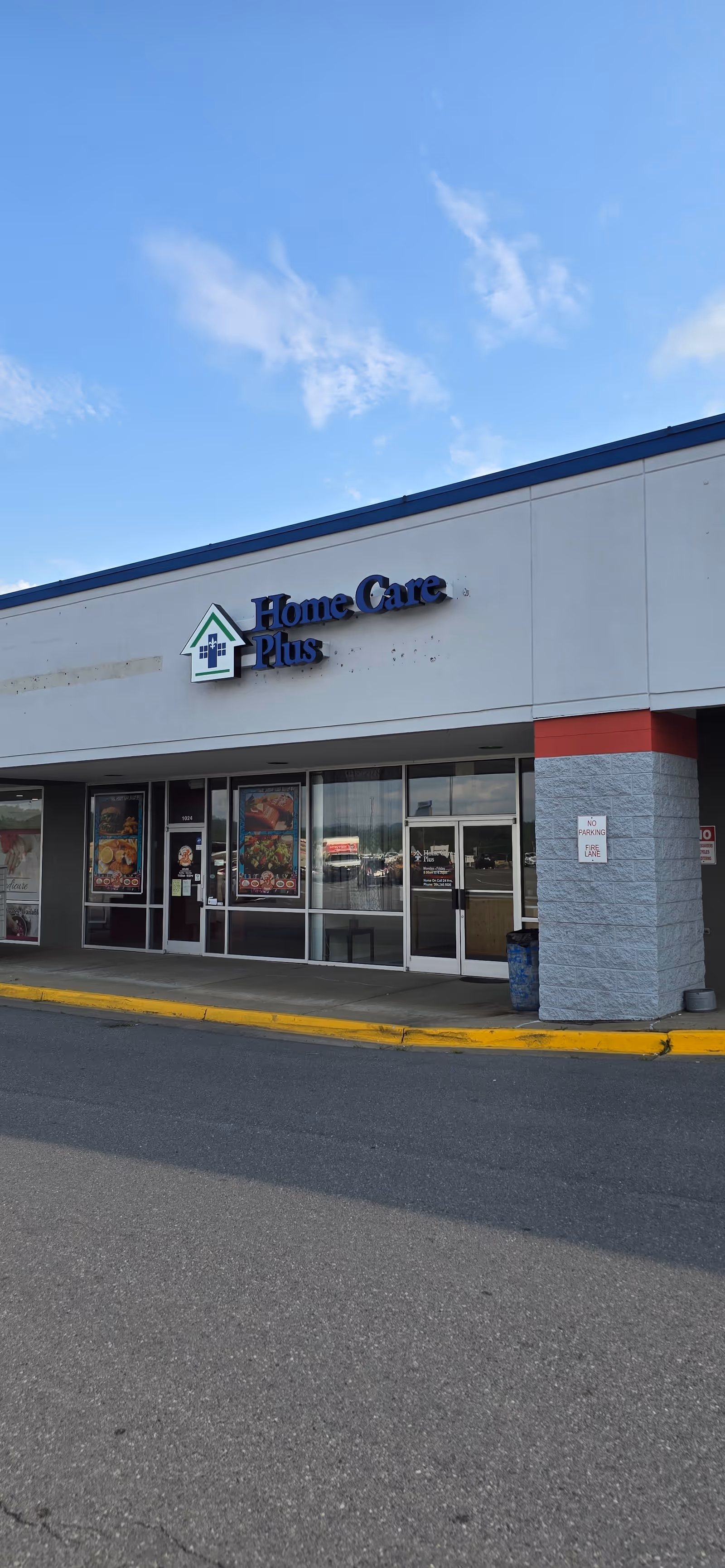 Exterior view of Home Care Plus storefront with glass doors and signage.