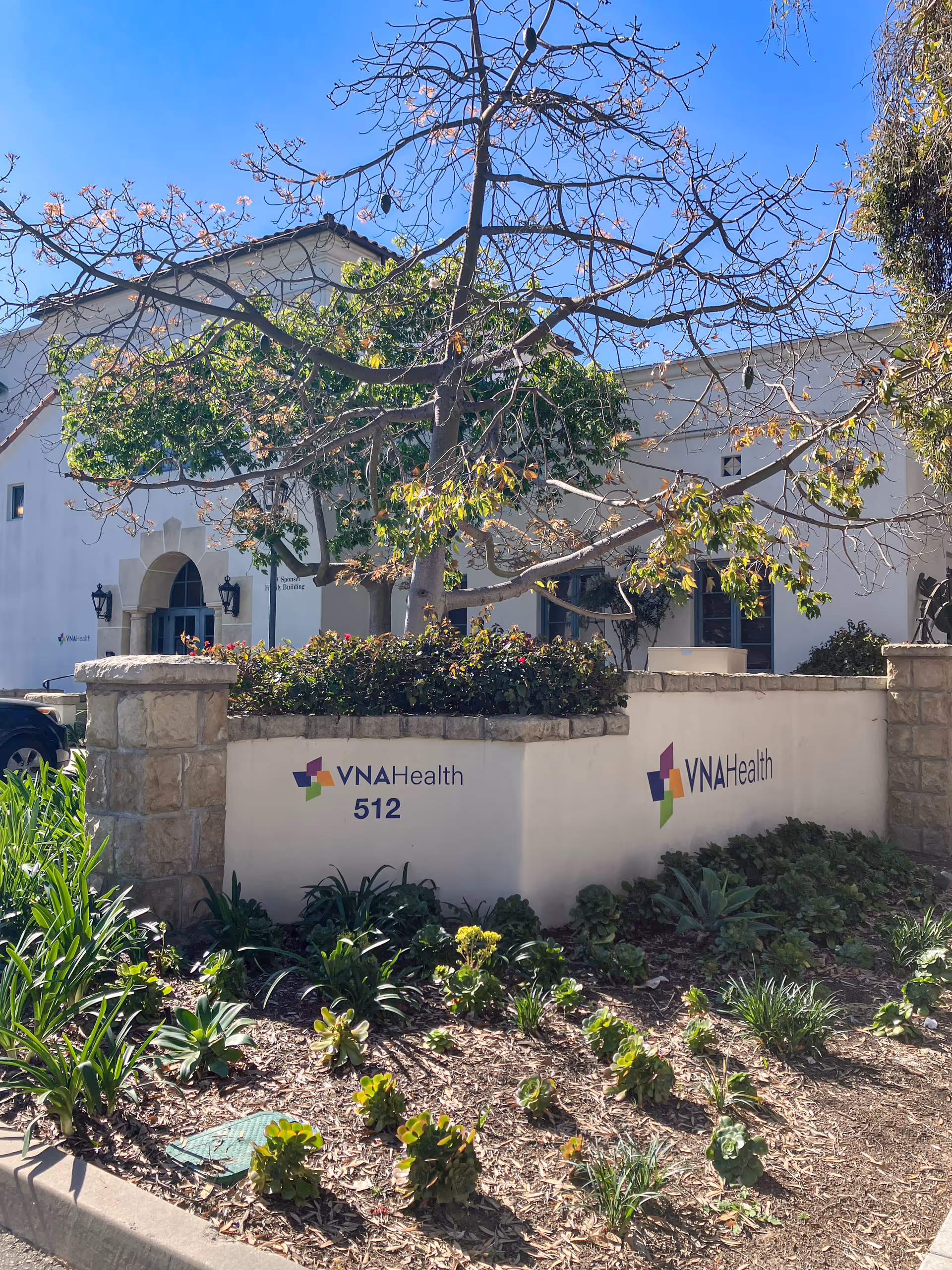 White VNA Health building front with landscaping and a 512 address sign.