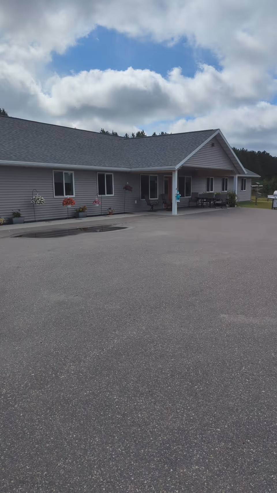 Single-story senior living facility exterior with a covered entrance and front porch.