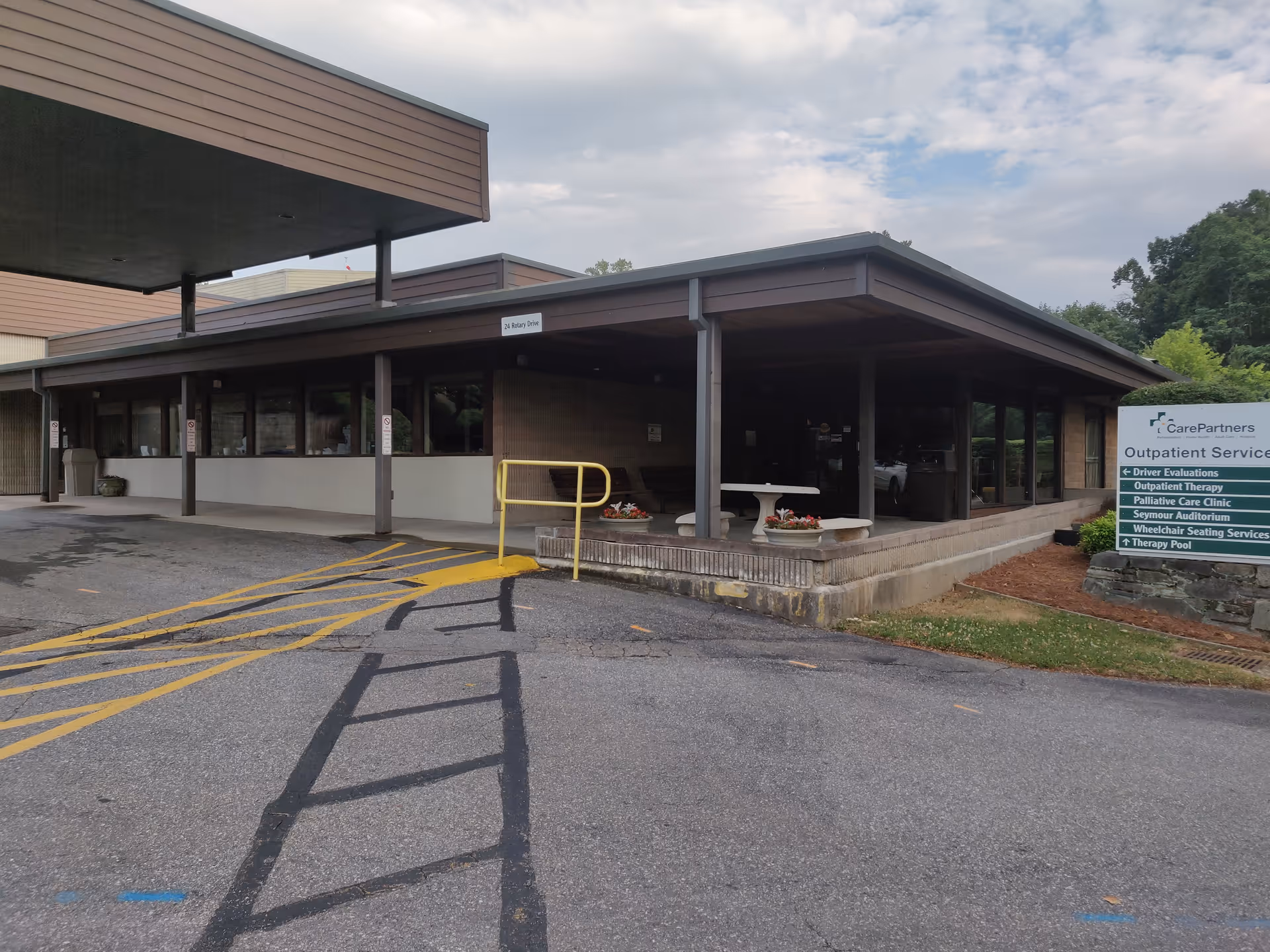 Exterior view of Care Partners Outpatient Services building with a covered entrance and sign.