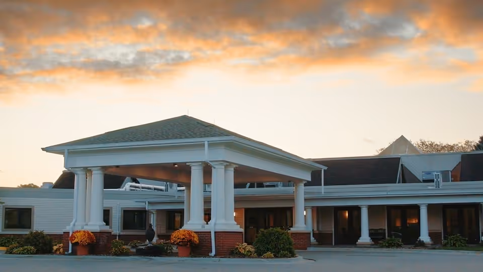 Front view of Friendship Village Kalamazoo building with white columns and a covered entrance.