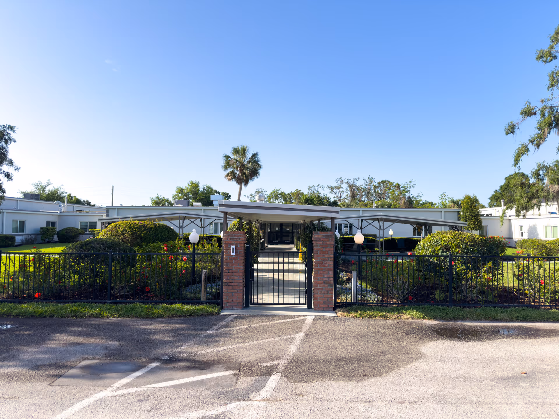 Exterior view of Avante at Mt Dora with gated entrance and landscaped grounds.