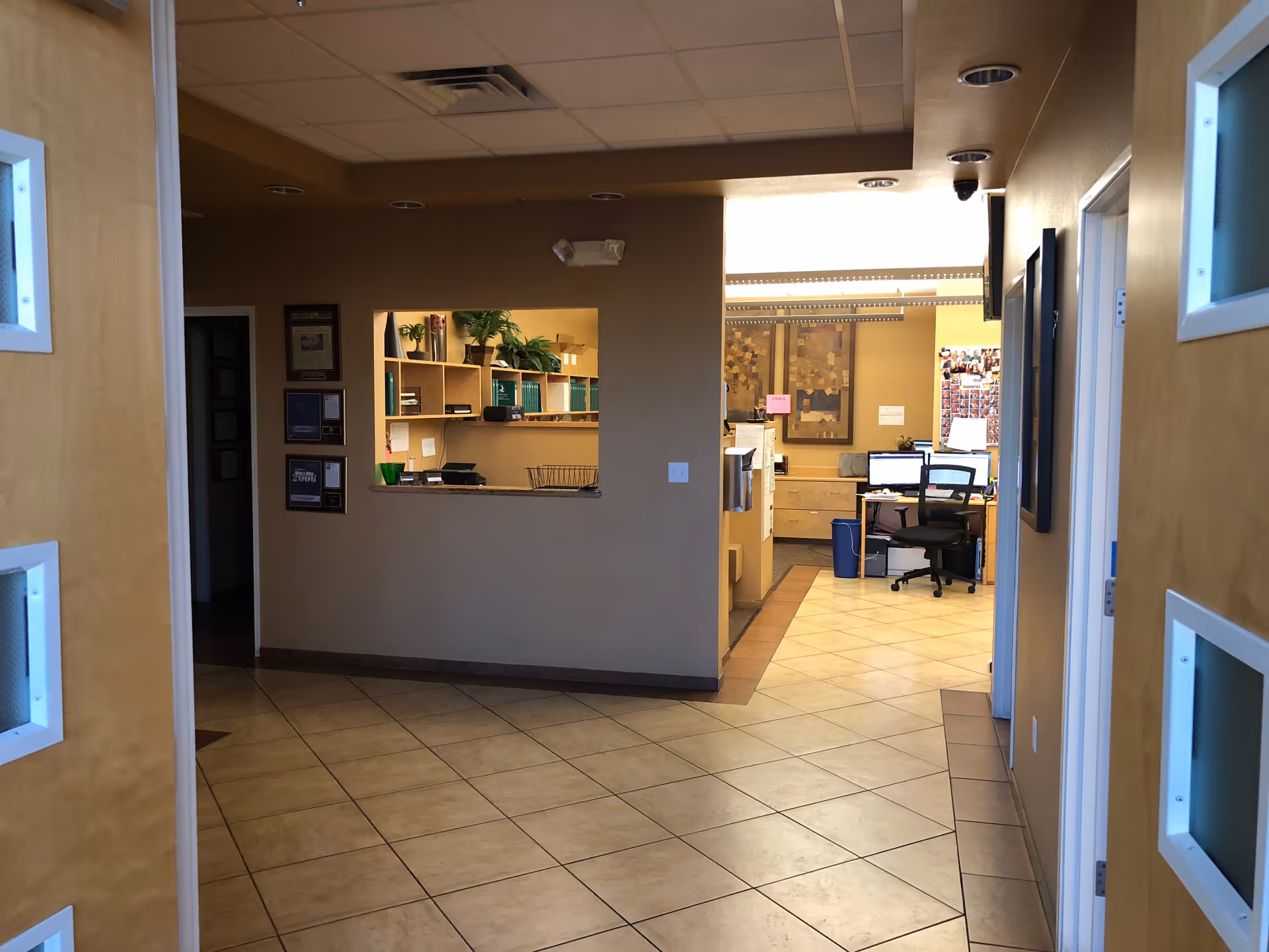 Interior lobby and reception area with a counter and workstations.