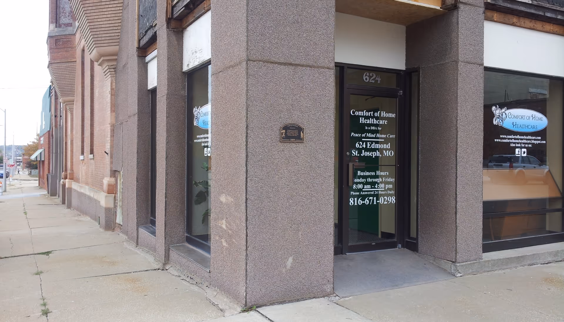 Exterior view of Comfort of Home Healthcare storefront with glass door and signage.