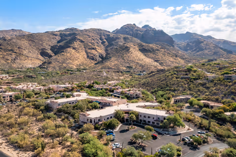 Aerial view of Brookdale Santa Catalina senior living campus amid desert mountains.