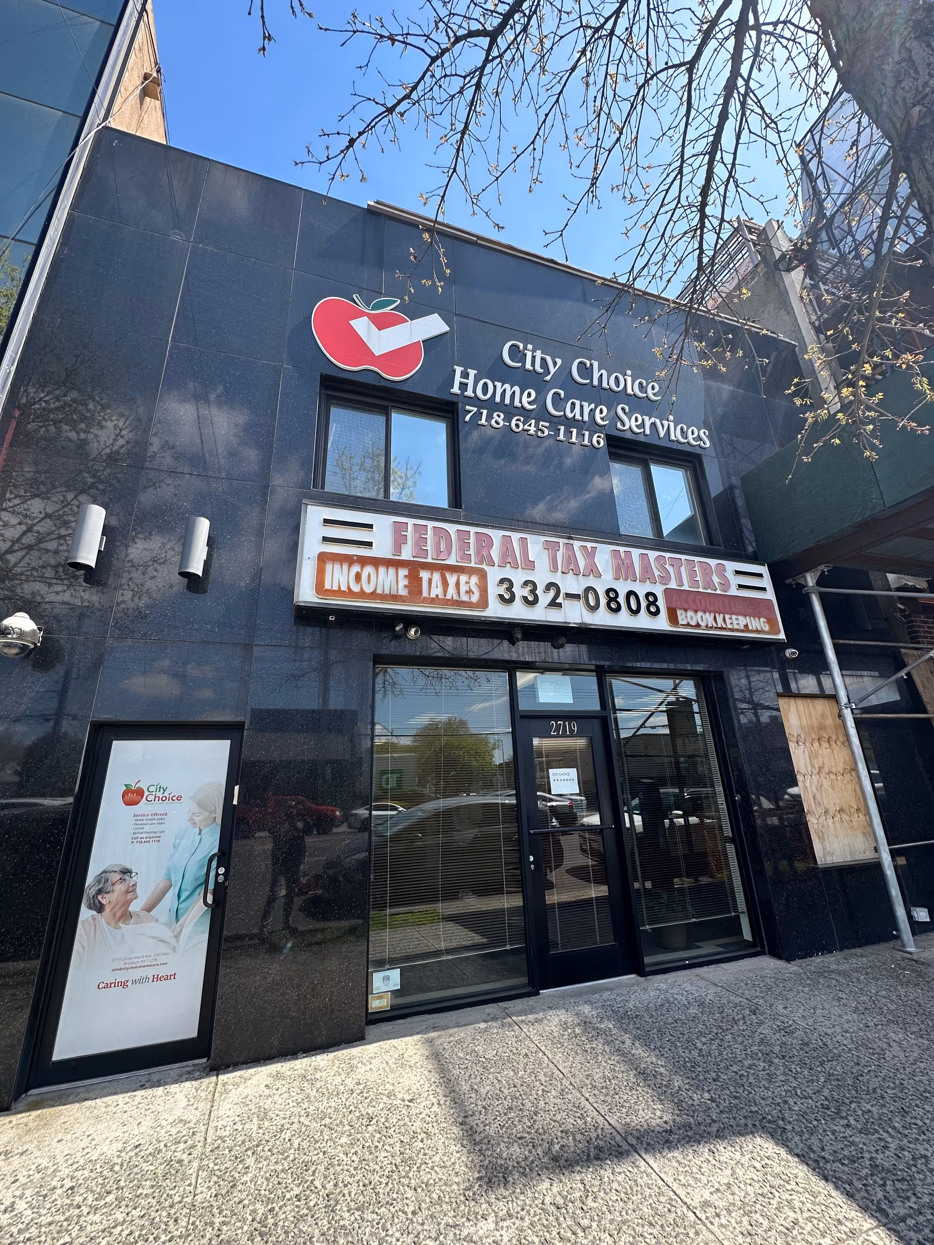 Front exterior of City Choice Home Care Services storefront with signage and a tax office marquee.