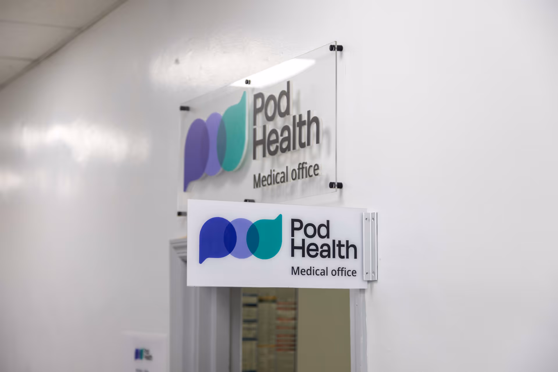 Interior hallway with Pod Health medical office signage on the wall.
