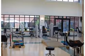 Bright Southington Care Center fitness room with gym equipment and residents visible.