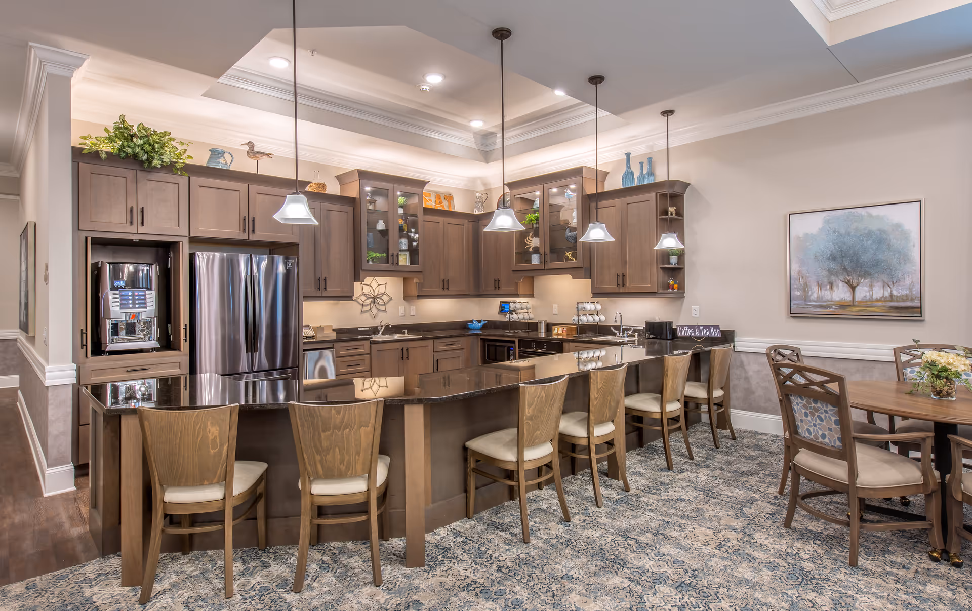 Modern kitchen with dark wood cabinets, stainless steel appliances, and a long island with seating.